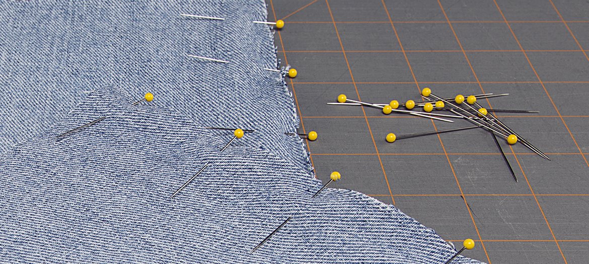 Plastic Yellow Head Quilters Pins On Cutting Mat with Fabric Squares